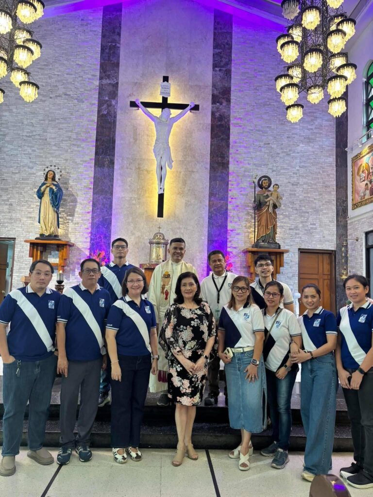 Eye Bank staff and priest group photo at the church altar
