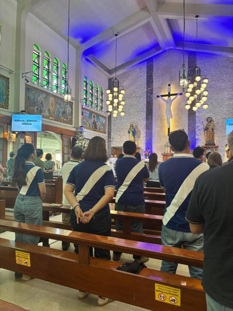 Eye Bank staff standing in the church pews during Mass