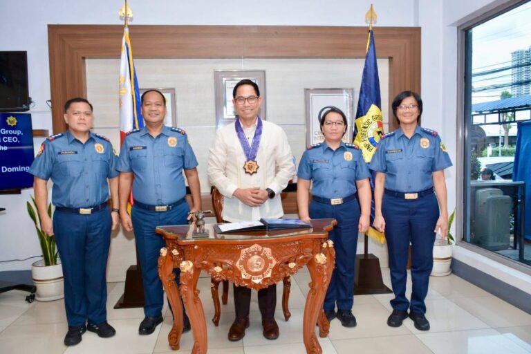 PNP Forensic Group officers with a guest in a barong in an office at Camp Crame