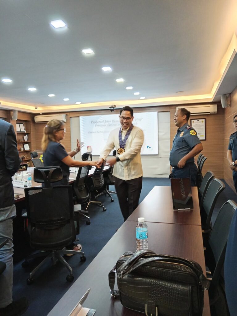 Participants greeting each other in the conference room