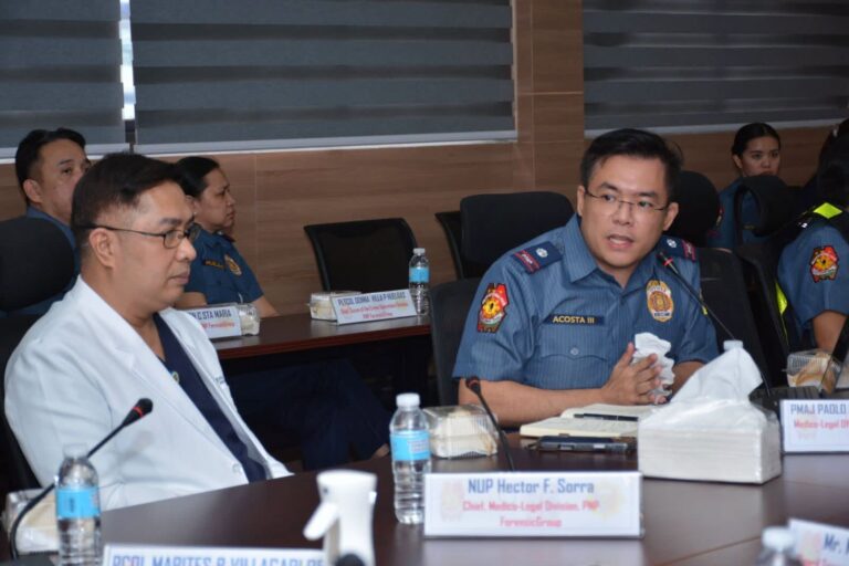 PNP officer and participant seated at the conference table