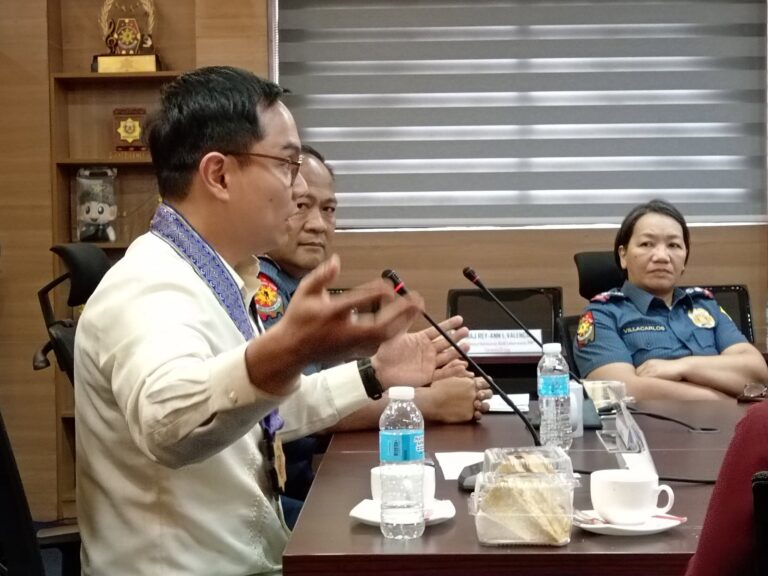 Participant in a barong gesturing while speaking at the meeting